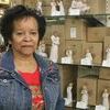 Gloria Walker stands in front of a Willow Tree ornament display