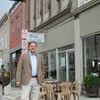 Bill Hart, Executive Director of Missouri Preservation Commission, walks downtown before the Macon Downtown Stroll. The Commission surveys downtowns to identify buildings with historical significance.